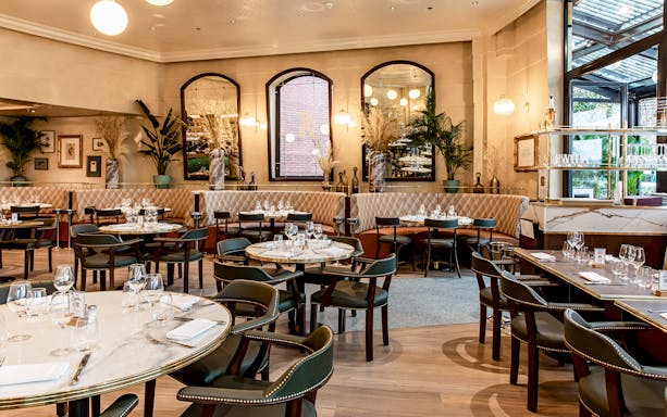 Breakfast spread at Brasserie Rosalie, Paris, featuring croissants, coffee, and fresh fruit.