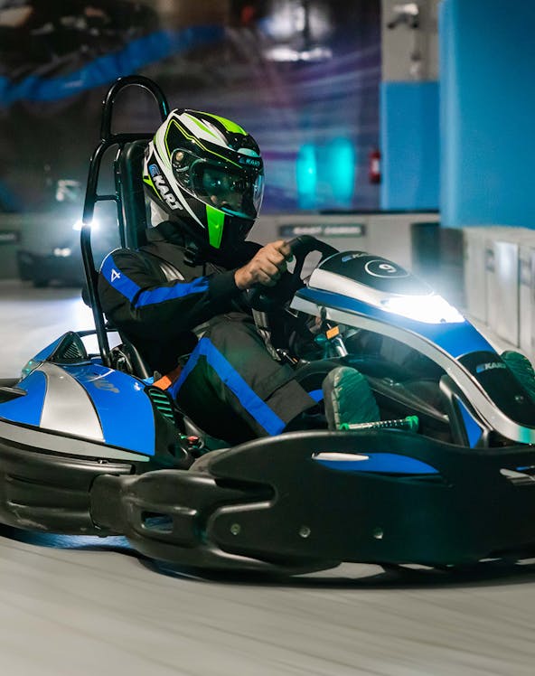 Go-kart racing at Ekart Dubai Mall indoor track.