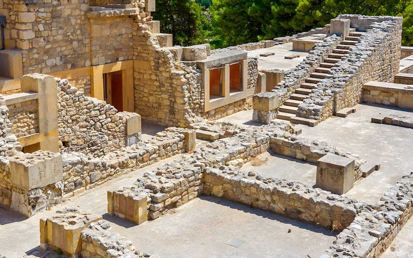 Knossos Palace ruins with stone rooms and stairs in Crete, Greece.