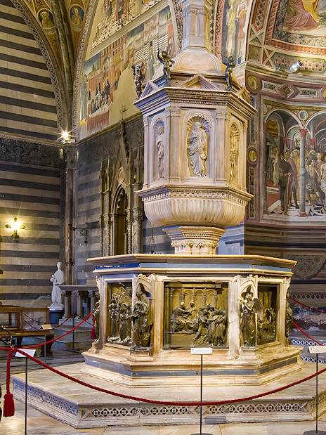 Siena Duomo interior with ornate pulpit and frescoes, part of OPA SI Pass tour.