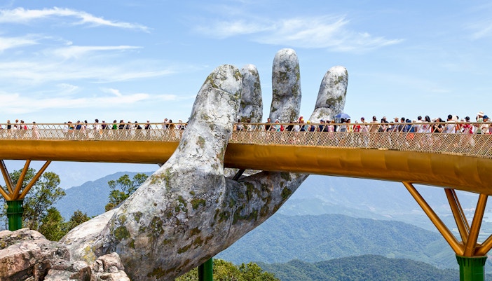 Tourists walk on the Golden Bridge