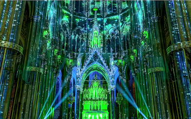 Votivkirche interior illuminated with green and blue lights during Light of Creation event in Vienna.