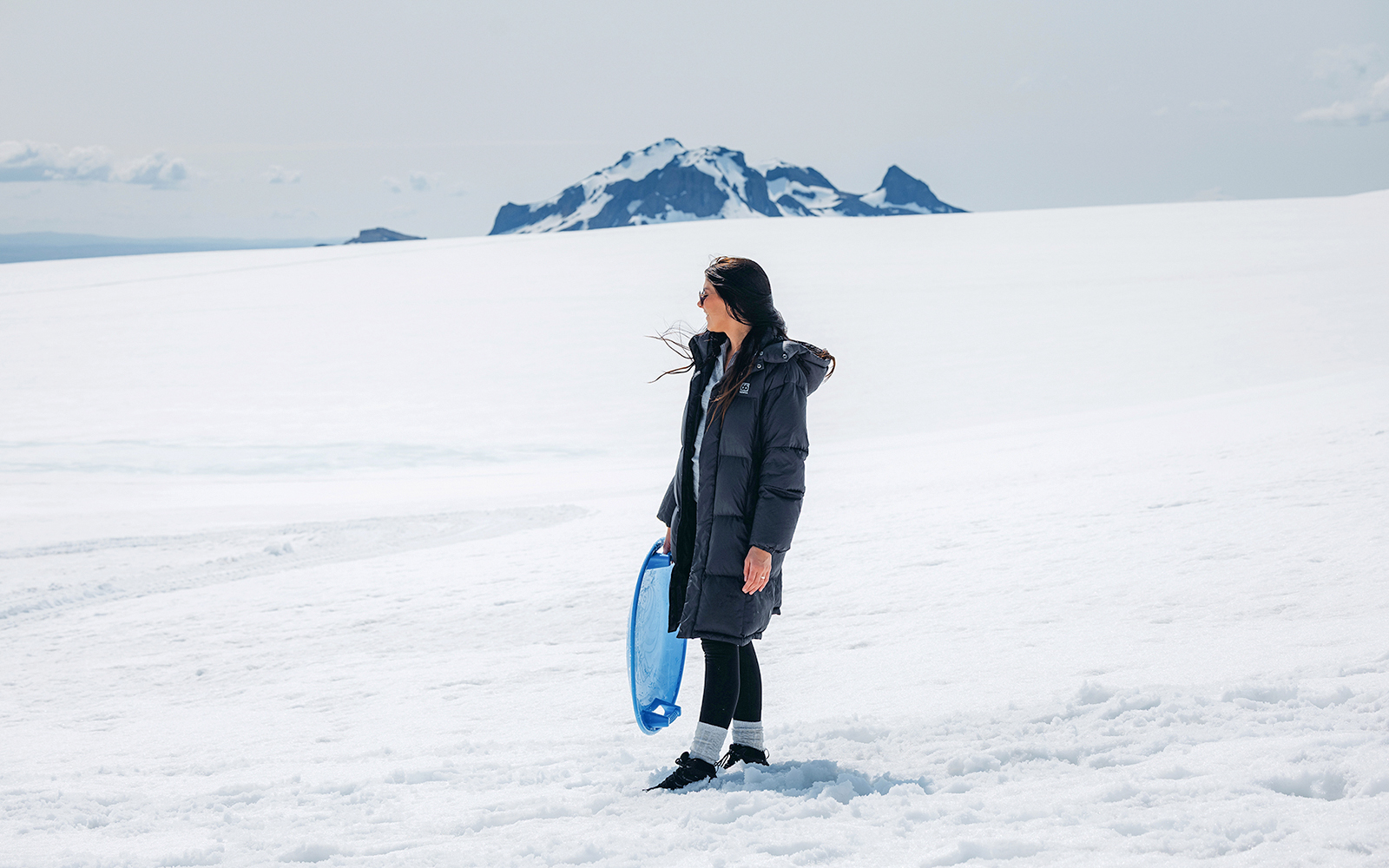 Guests exploring Langjökull Glacier with sled during Red Glacier Monster Truck Tour.