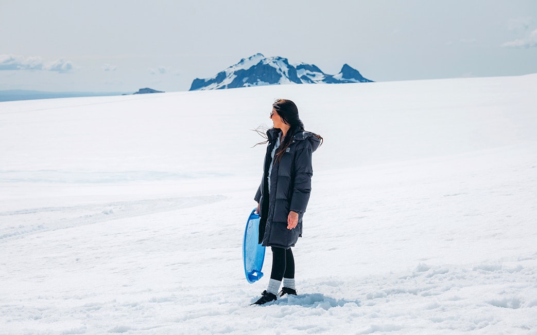 Guests exploring Langjökull Glacier with sled during Red Glacier Monster Truck Tour.