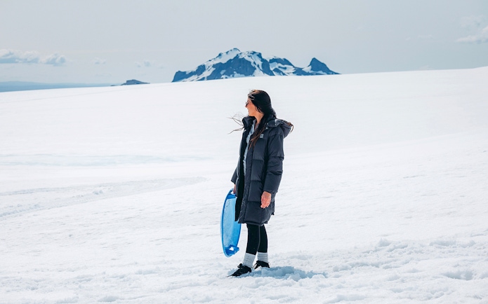 Guests exploring Langjökull Glacier with sled during Red Glacier Monster Truck Tour.