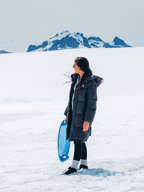 Guests exploring Langjökull Glacier with sled during Red Glacier Monster Truck Tour.