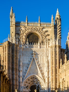 Seville Cathedral facade with intricate Gothic details and Giralda tower.
