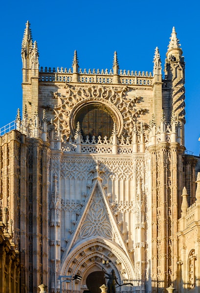 Seville Cathedral facade with intricate Gothic details and Giralda tower.