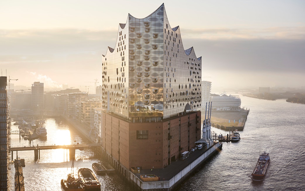 Elbphilharmonie Hamburg at sunrise, view of the harbor and cityscape.