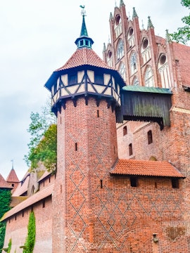 Malbork Castle brick tower with decorative patterns and Gothic architecture.
