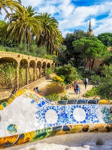 Serpentine benches in Park Güell with view of Greek Theatre, Barcelona.