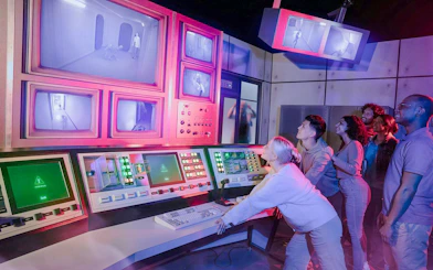 Guests interacting with control panels at Stranger Things games, Netflix House, Philadelphia.