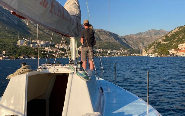 Yacht sailing near Dubrovnik with view of Elaphiti Islands in the distance.