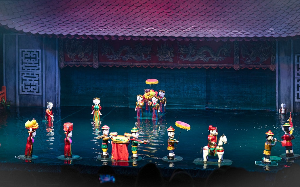 Water puppet performance in Ho Chi Minh City with colorful puppets on water stage.
