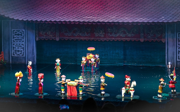 Water puppet performance in Ho Chi Minh City with colorful puppets on water stage.