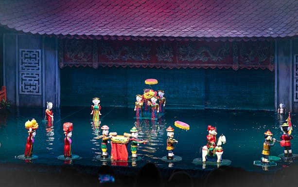 Water puppet performance in Ho Chi Minh City with colorful puppets on water stage.
