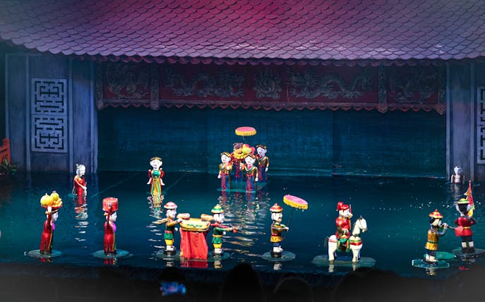 Water puppet performance in Ho Chi Minh City with colorful puppets on water stage.