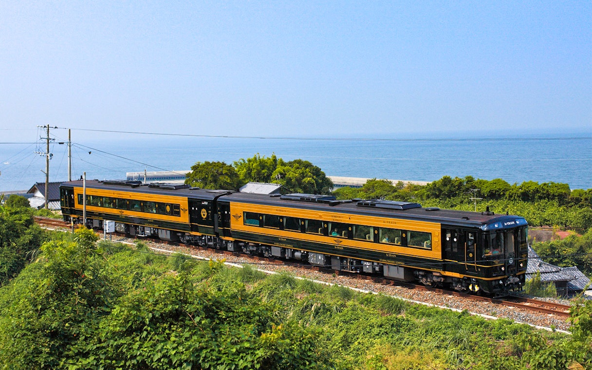 Scenic train journey along Kyushu coast with ocean view, All Kyushu Area Pass.