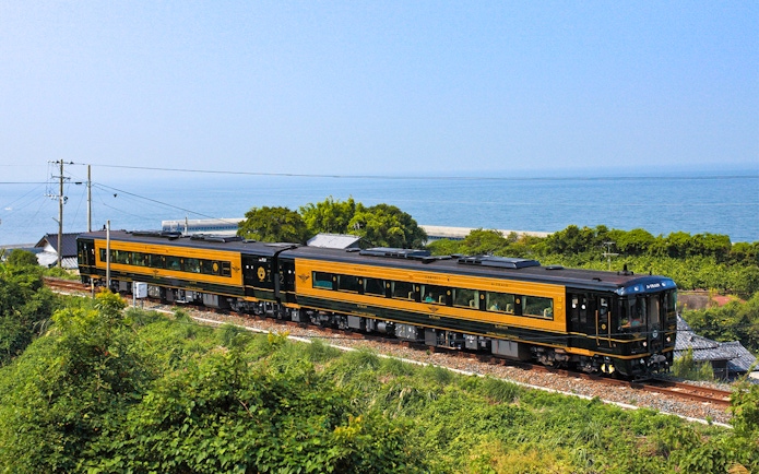 Scenic train journey along Kyushu coast with ocean view, All Kyushu Area Pass.