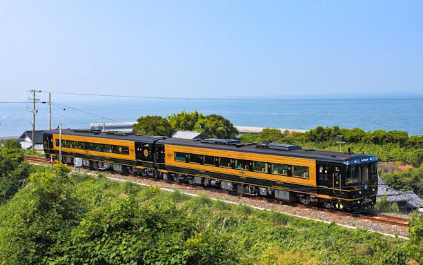 Scenic train journey along Kyushu coast with ocean view, All Kyushu Area Pass.