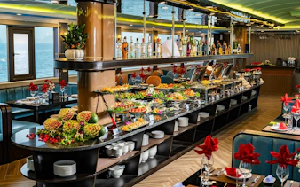 Luxurious buffet setup on La Casta Day Cruise, Ha Long Bay, featuring gourmet dishes and elegant decor.