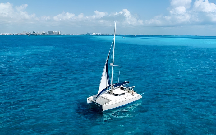 Catamaran sailing on turquoise waters near Isla Mujeres.