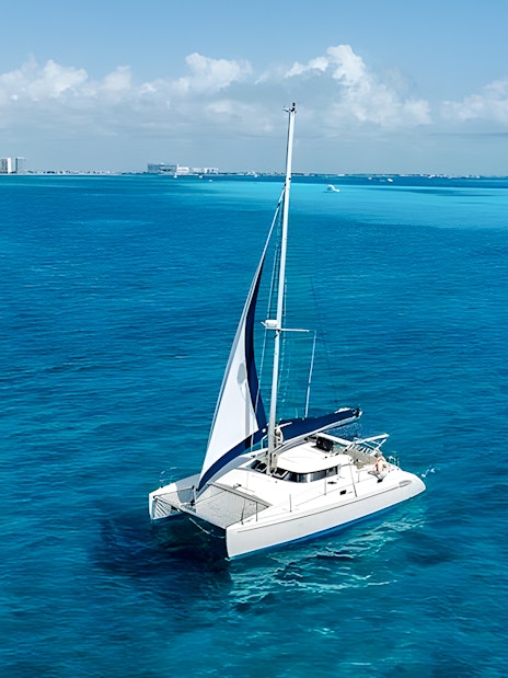 Catamaran sailing on turquoise waters near Isla Mujeres.