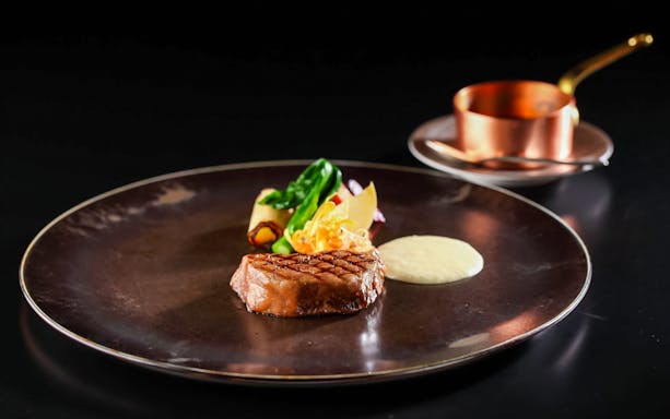 Steak with vegetables and sauce at Sky Restaurant 634 Grand Room Luxe Dinner.