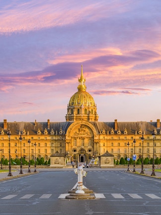 Army Museum in Paris with golden dome at sunset.