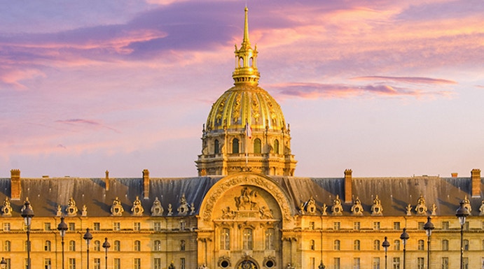 Army Museum in Paris with golden dome at sunset.
