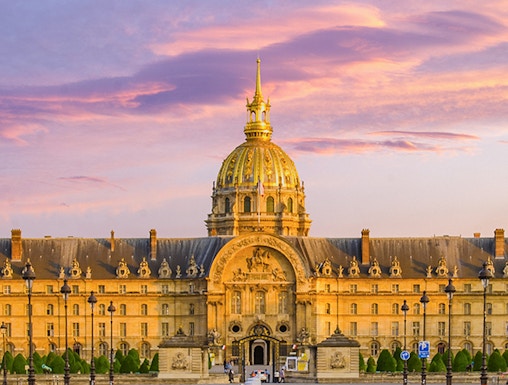 Army Museum in Paris with golden dome at sunset.