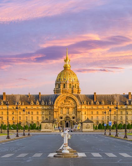 Army Museum in Paris with golden dome at sunset.