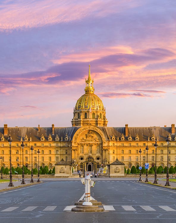 Army Museum in Paris with golden dome at sunset.