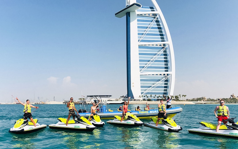 Tourists on jet skis near Burj Al Arab in Dubai.