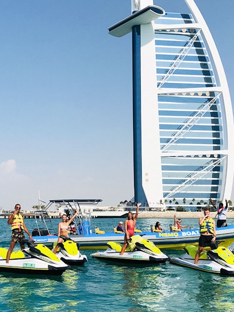 Tourists on jet skis near Burj Al Arab in Dubai.