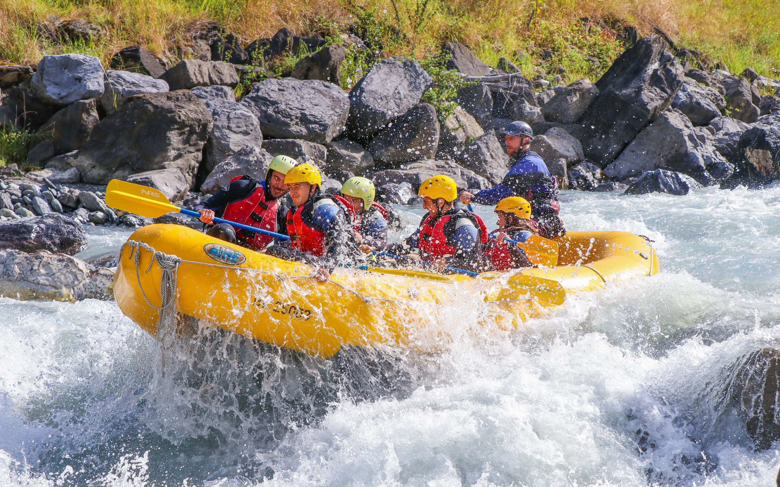 Group river rafting on a rapid in Interlaken, Switzerland.