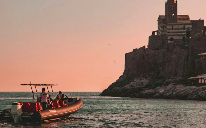 Boat near Portovenere with sunset view, La Spezia: Portovenere and 3 Islands Boat Trip.