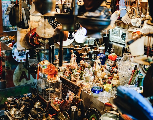 Antique figurines and vintage items displayed in a crowded shop.