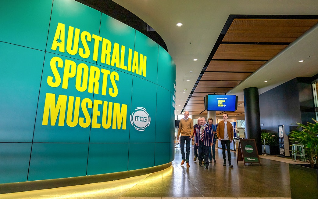 Australian Sports Museum entrance with visitors on MCG tour.