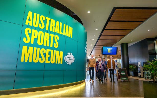 Australian Sports Museum entrance with visitors on MCG tour.