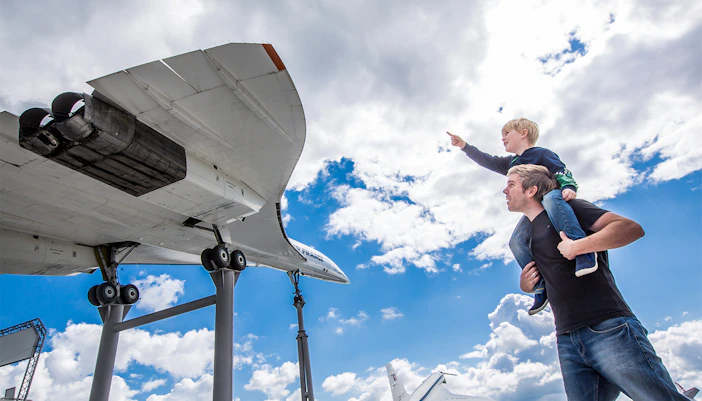 Visitors observing Tupolev aircraft at Technik Museum Sinsheim.