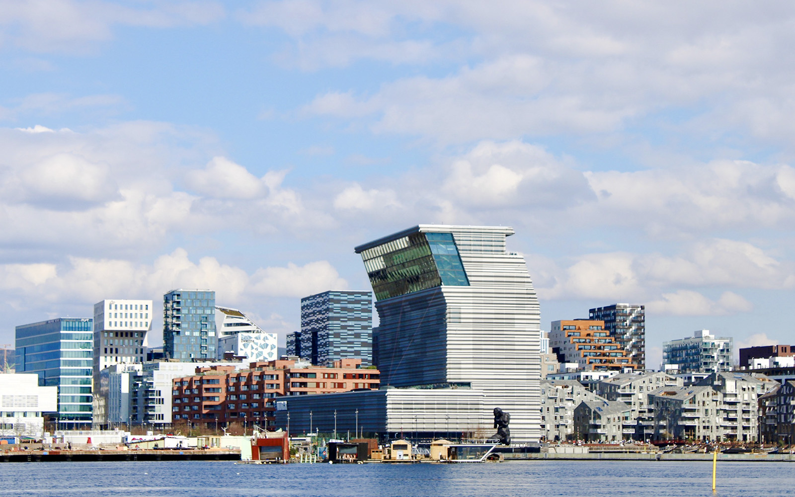 Oslo skyline with modern architecture viewed from Oslofjord during sightseeing cruise.