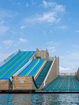 Colorful slides at Hatta Wadi Hub, Dubai, with #visithatta signage.