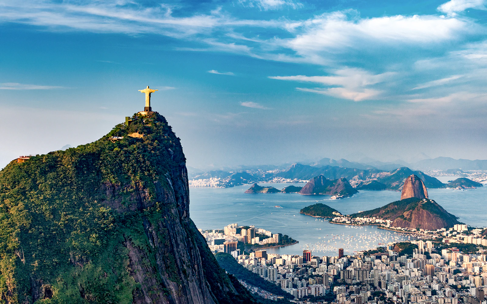 Aerial view of Christ the Redeemer statue and Rio de Janeiro coastline from a helicopter.