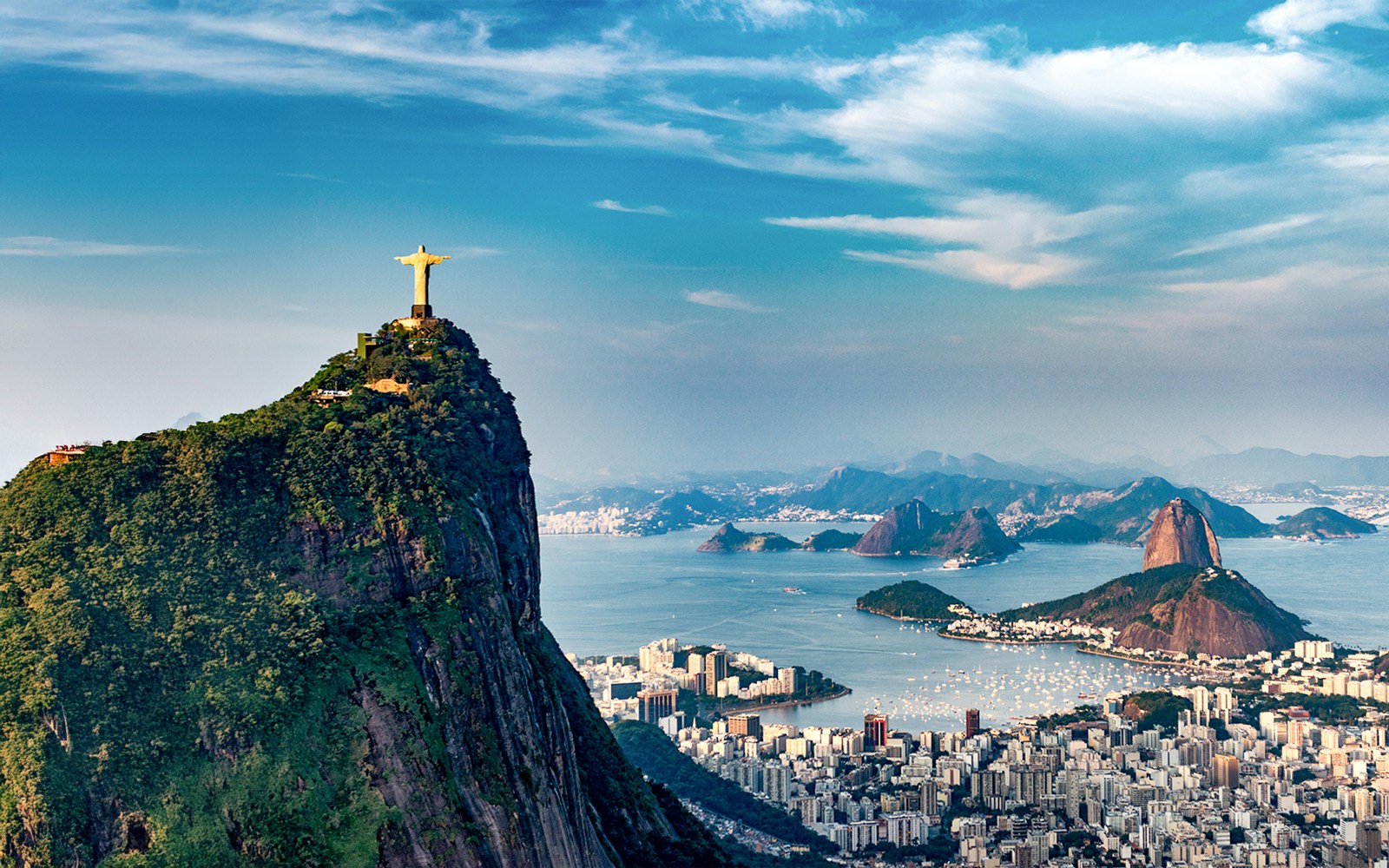 Aerial view of Christ the Redeemer statue and Rio de Janeiro coastline from a helicopter.