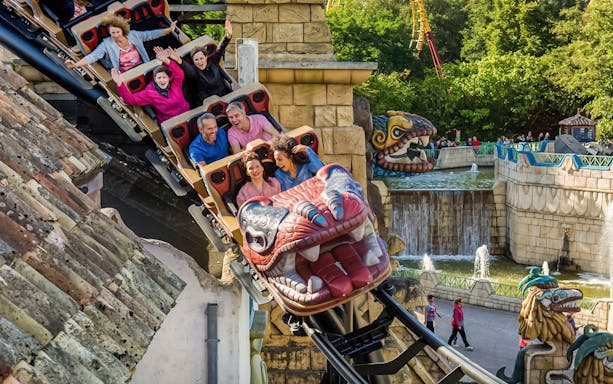 Tourists on Huracan ride at Bellewaerde Park, Belgium, enjoying thrilling loops.