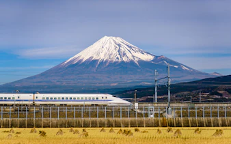 High-speed train passing in front of Mt. Fuji, Japan.