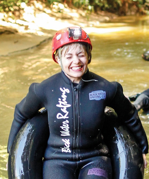 Participants enjoying black water rafting in Waitomo cave stream.