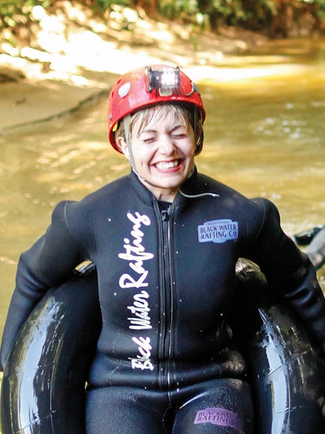 Participants enjoying black water rafting in Waitomo cave stream.