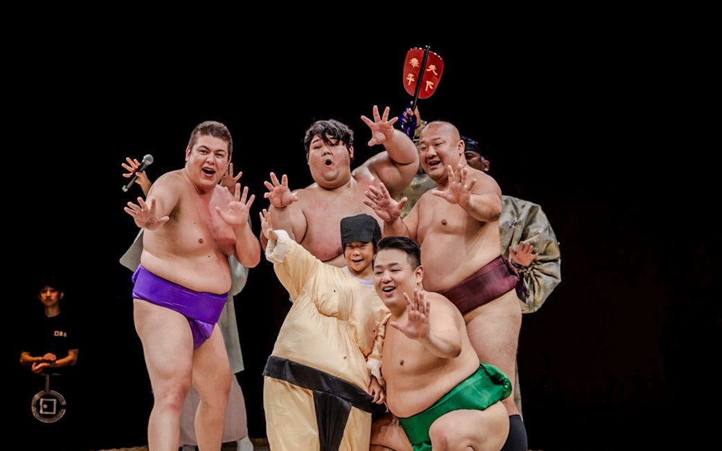 Sumo wrestlers posing at The Sumo Hall Hirakuza in Osaka.